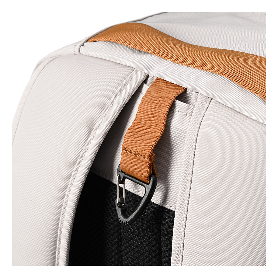 Ritual Covert hockey backpack white with a brown strap and silver buckle, closeup view