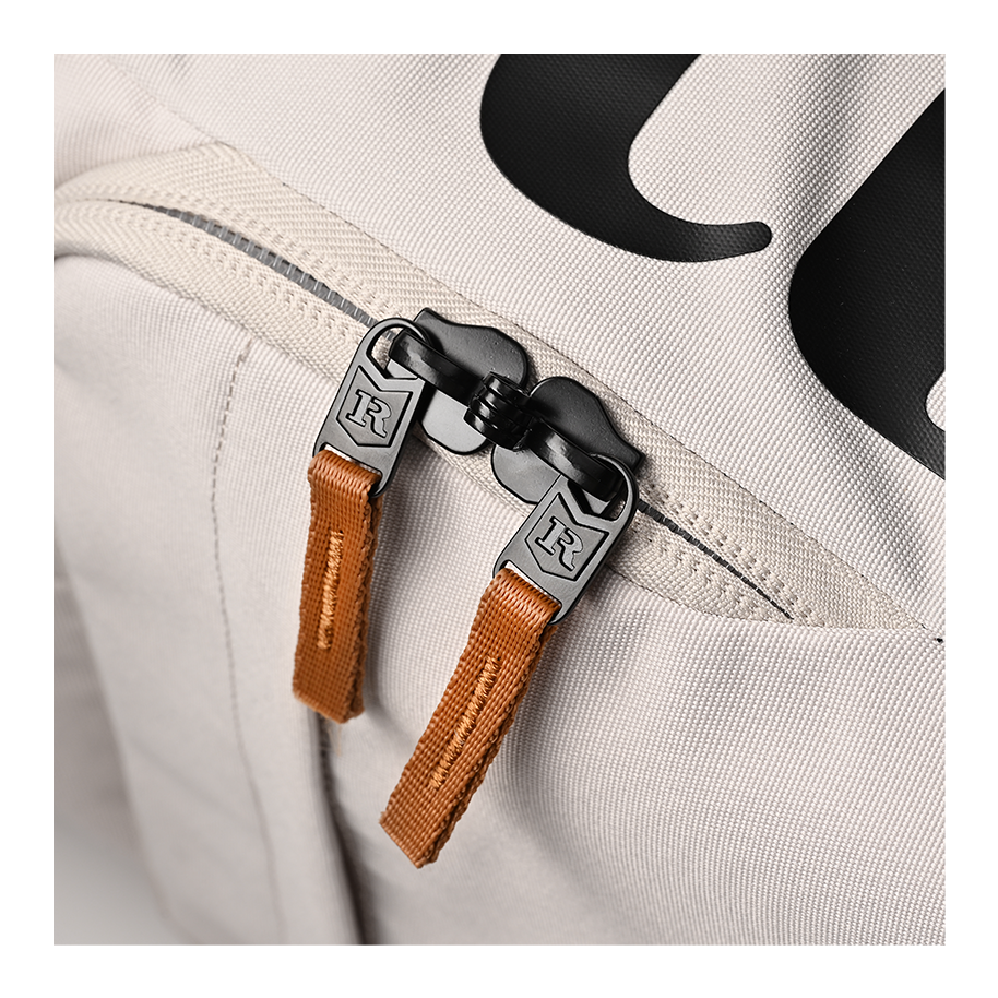 Ritual Mission combo hockey bag white with brown straps and black zippers, close-up view