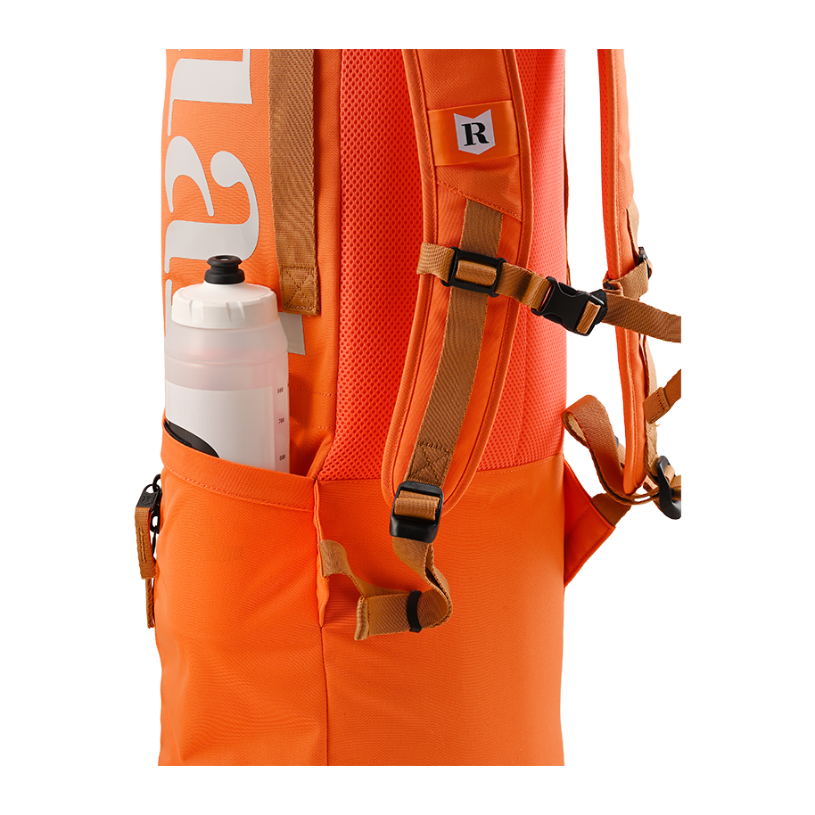 Ritual Hockey orange tactic stick bag with brown straps and a water bottle in a pocket